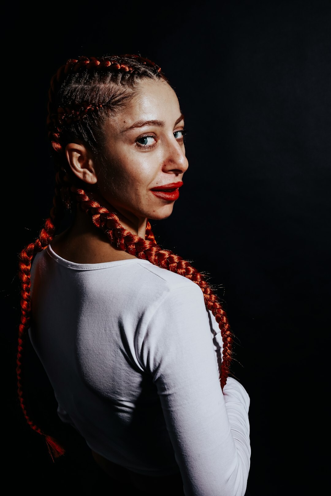 Studio portrait of a young woman with braided hair